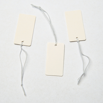 Metka z gumką do bizuterii biała 18x36mm