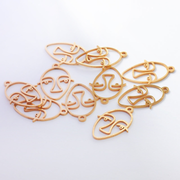 Zawieszka ze stali chirurgicznej głowa artysty w kolorze złotym 27mm